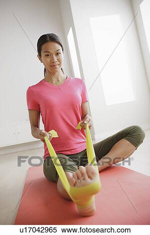 Young woman exercising View Large Photo Image Stock Photography - Young woman exercising. Fotosearch