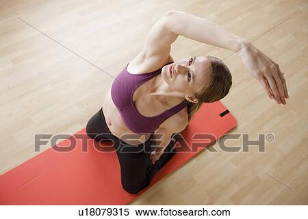 Stock Photography - Young woman exercising. Fotosearch