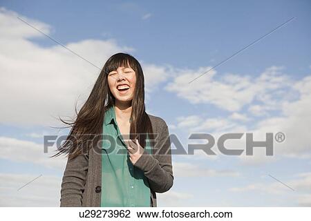 Young woman laughing View Large Photo Image Stock Image - Young woman laughing. Fotosearch