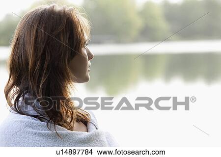 Young woman looking at lakeside View Large Photo Image Picture - Young woman looking at lakeside. Fotosearch