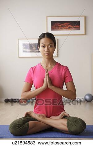 Stock Image - Young woman meditating. Fotosearch
