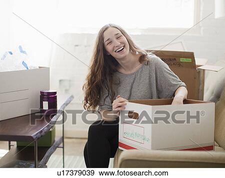 Young woman moving into new flat View Large Photo Image Stock Photo - Young woman moving into new flat. Fotosearch