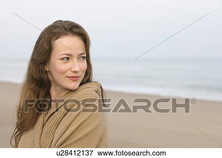 Stock Photo - Young woman on empty beach. Fotosearch