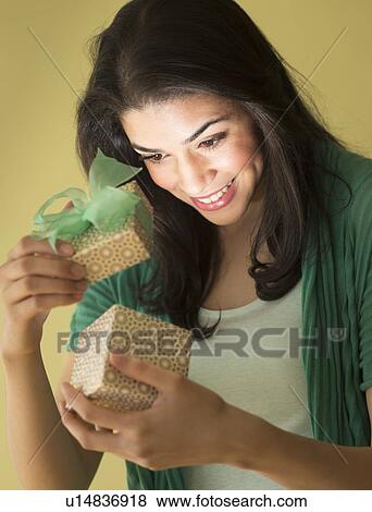 Young woman opening gift box View Large Photo Image Stock Photo - Young woman opening gift box. Fotosearch