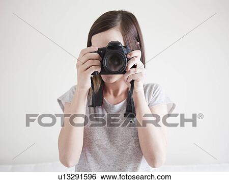 Young woman playing with digital camera View Large Photo Image Stock Photograph - Young woman playing with digital camera. Fotosearch