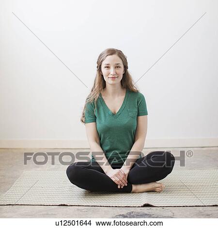 Picture - Young woman practicing yoga. Fotosearch
