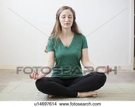 Picture - Young woman practicing yoga. Fotosearch