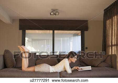 Stock Image - Young woman reading book. Fotosearch