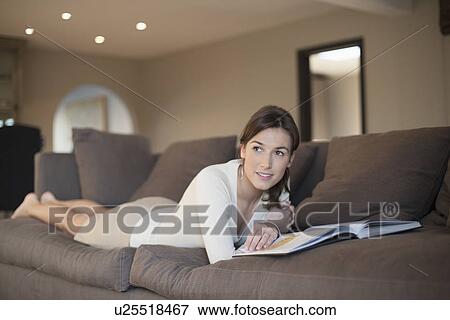 Stock Photo - Young woman reading book. Fotosearch
