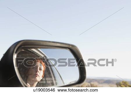 Young woman reflecting in car wing View Large Photo Image Stock Photograph - Young woman reflecting in car wing. Fotosearch