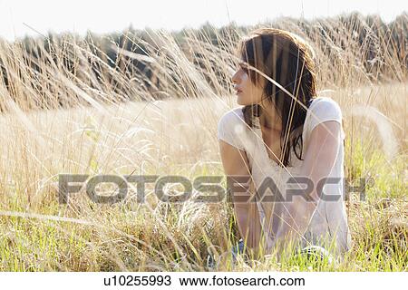 Young woman relaxing on meadow View Large Photo Image Stock Image - Young woman relaxing on meadow. Fotosearch