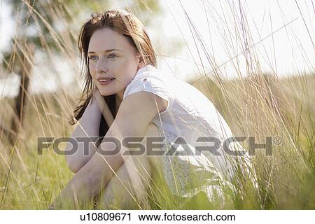 Young woman relaxing on meadow View Large Photo Image Stock Image - Young woman relaxing on meadow. Fotosearch