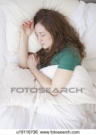 Young woman sleeping in bed View Large Photo Image Stock Photograph - Young woman sleeping in bed. Fotosearch