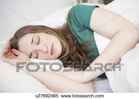 Young woman sleeping in bed View Large Photo Image Stock Photography - Young woman sleeping in bed. Fotosearch