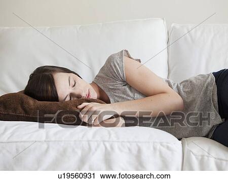 Young woman sleeping on sofa View Large Photo Image Stock Image - Young woman sleeping on sofa. Fotosearch