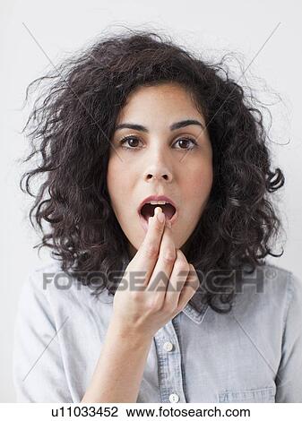 Young woman taking pill View Large Photo Image Stock Image - Young woman taking pill. Fotosearch