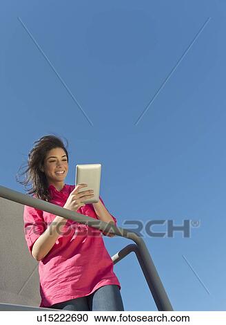 Young woman using tablet pc View Large Photo Image Stock Image - Young woman using tablet pc. Fotosearch
