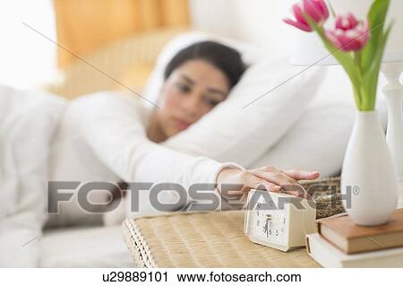 Stock Image - Young woman waking up. Fotosearch