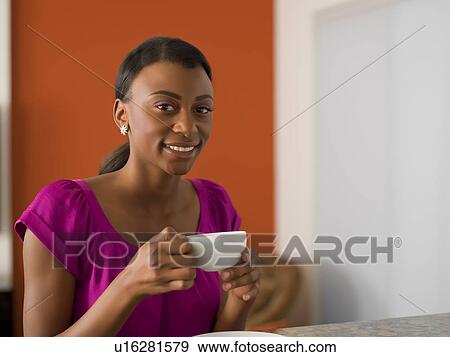 Young woman with cup of coffee View Large Photo Image Stock Photo - Young woman with cup of coffee. Fotosearch