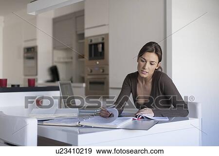 Young woman working from home View Large Photo Image Stock Photo - Young woman working from home. Fotosearch