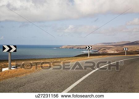Arrows along rural coastal road, Mirleft, Morocco View Large Photo Image Stock Photograph - Arrows along rural coastal road, Mirleft, Morocco. Fotosearch