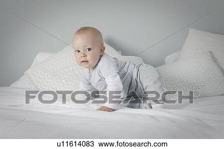 Baby boy crawling on bed View Large Photo Image Stock Image - Baby boy crawling on bed . Fotosearch