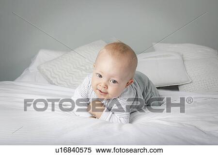 Baby boy crawling on bed View Large Photo Image Stock Photography - Baby boy crawling on bed . Fotosearch