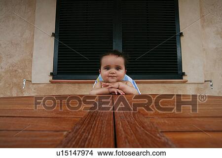 Baby boy sitting in high chair at table View Large Photo Image Picture - Baby boy sitting in high chair at table. Fotosearch