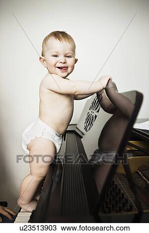 Baby girl climbing on piano View Large Photo Image Stock Image - Baby girl climbing on piano. Fotosearch