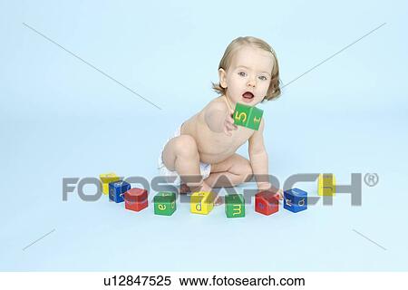 Baby girl playing with colored blocks View Large Photo Image Stock Photography - Baby girl playing with colored blocks. Fotosearch
