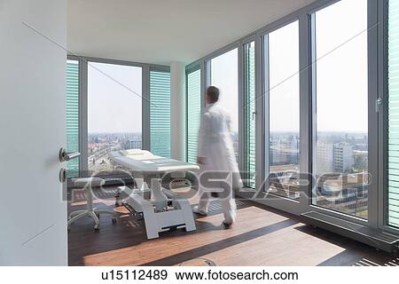 Stock Photo - Blurred view of doctor in office. Fotosearch
