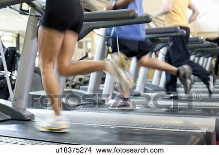 Blurred view of people on treadmills View Large Photo Image Picture - Blurred view of people on treadmills. Fotosearch