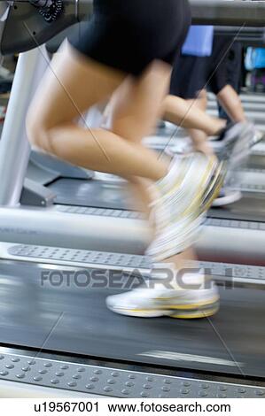 Blurred view of people on treadmills View Large Photo Image Stock Image - Blurred view of people on treadmills. Fotosearch