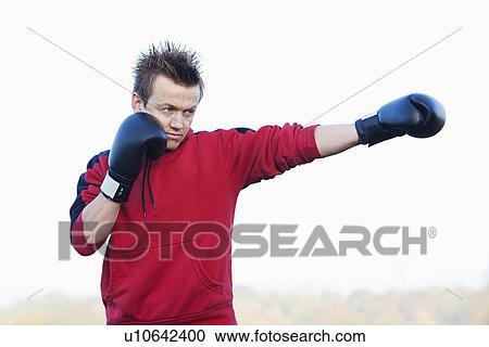 Boxer throwing punches outdoors View Large Photo Image Stock Image - Boxer throwing punches outdoors. Fotosearch