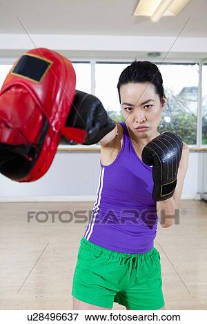 Stock Photo - Boxer training with coach in gym. Fotosearch