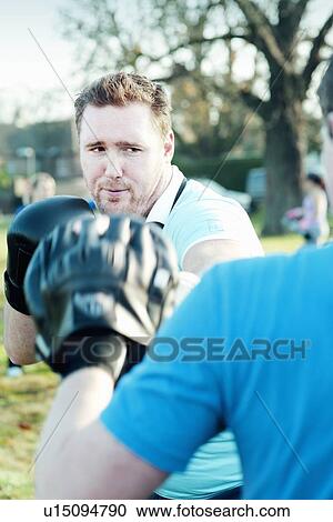 Boxer training with coach outdoors View Large Photo Image Stock Image - Boxer training with coach outdoors. Fotosearch