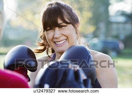 Stock Photo - Boxer training with coach outdoors. Fotosearch