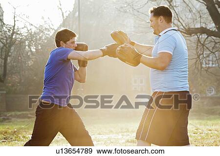 Boxer training with coach outdoors View Large Photo Image Stock Photo - Boxer training with coach outdoors. Fotosearch