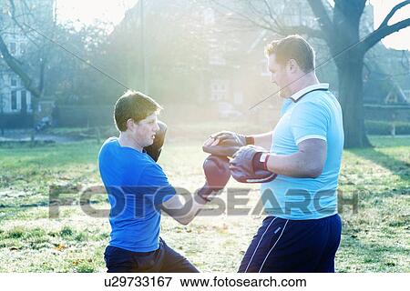 Boxer training with coach outdoors View Large Photo Image Stock Photo - Boxer training with coach outdoors. Fotosearch