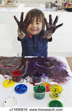 Boy finger painting on paper View Large Photo Image Stock Photograph - Boy finger painting on paper. Fotosearch