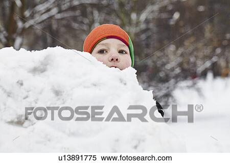 Boy playing in snow in park View Large Photo Image Stock Photography - Boy playing in snow in park. Fotosearch