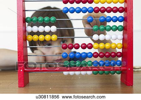Boy playing with abacus View Large Photo Image Stock Photograph - Boy playing with abacus. Fotosearch