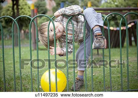 Boy playing with ball on playground View Large Photo Image Stock Photography - Boy playing with ball on playground. Fotosearch