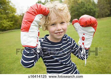 Boy playing with boxing gloves outdoors View Large Photo Image Stock Photography - Boy playing with boxing gloves outdoors. Fotosearch