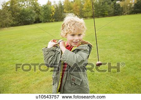 Stock Photo - Boy playing with chestnut on string. Fotosearch