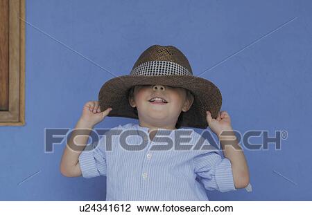 Boy playing with fathers hat View Large Photo Image Stock Image - Boy playing with fathers hat. Fotosearch