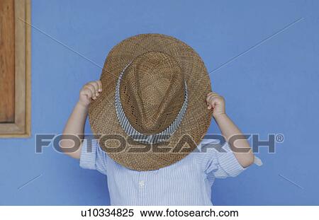 Boy playing with fathers hat View Large Photo Image Stock Photography - Boy playing with fathers hat. Fotosearch