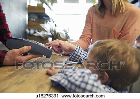 Boy using credit card machine in store View Large Photo Image Stock Image - Boy using credit card machine in store. Fotosearch