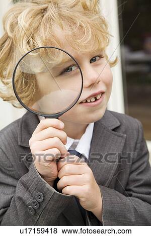 Boy using magnifying glass outdoors View Large Photo Image Stock Photo - Boy using magnifying glass outdoors. Fotosearch