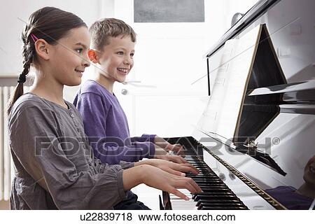 Brother and sister playing piano View Large Photo Image Stock Photo - Brother and sister playing piano. Fotosearch